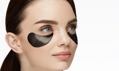 Beautiful Face With Patches Under Eyes Beautiful Face With Patches Under Eyes. Attractive Smiling Female Model With Fresh Look, Natural Makeup And Black Eye Patches On Skin. High Resolution
